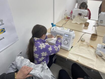 Child using a sewing machine