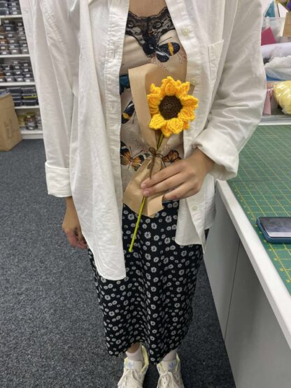 Lady holding a crocheted flower