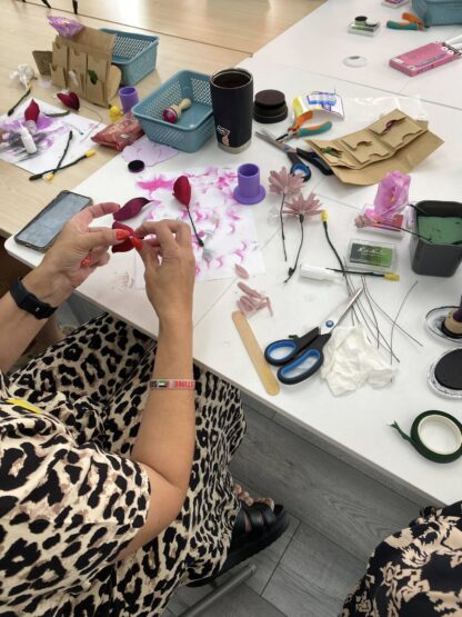 Lady creating paper craft flowers