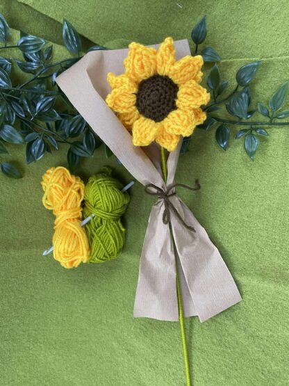 Crocheted flower with balls of yarn