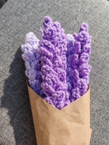 Bunch of hand made lavender sprigs in a vase, wrapped in brown paper
