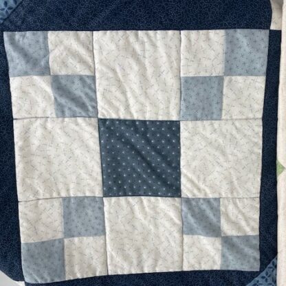 Quilting block showing a 9 patch in a different colour range