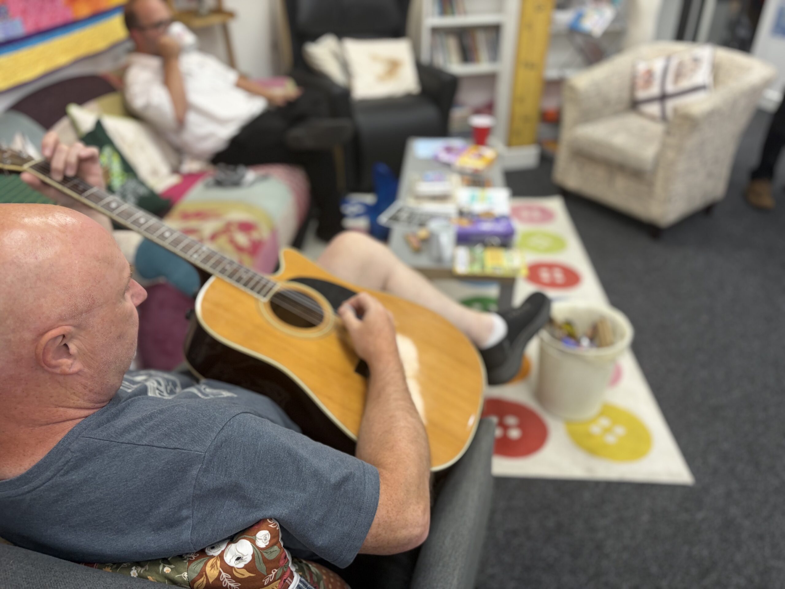 man sat playing guitar